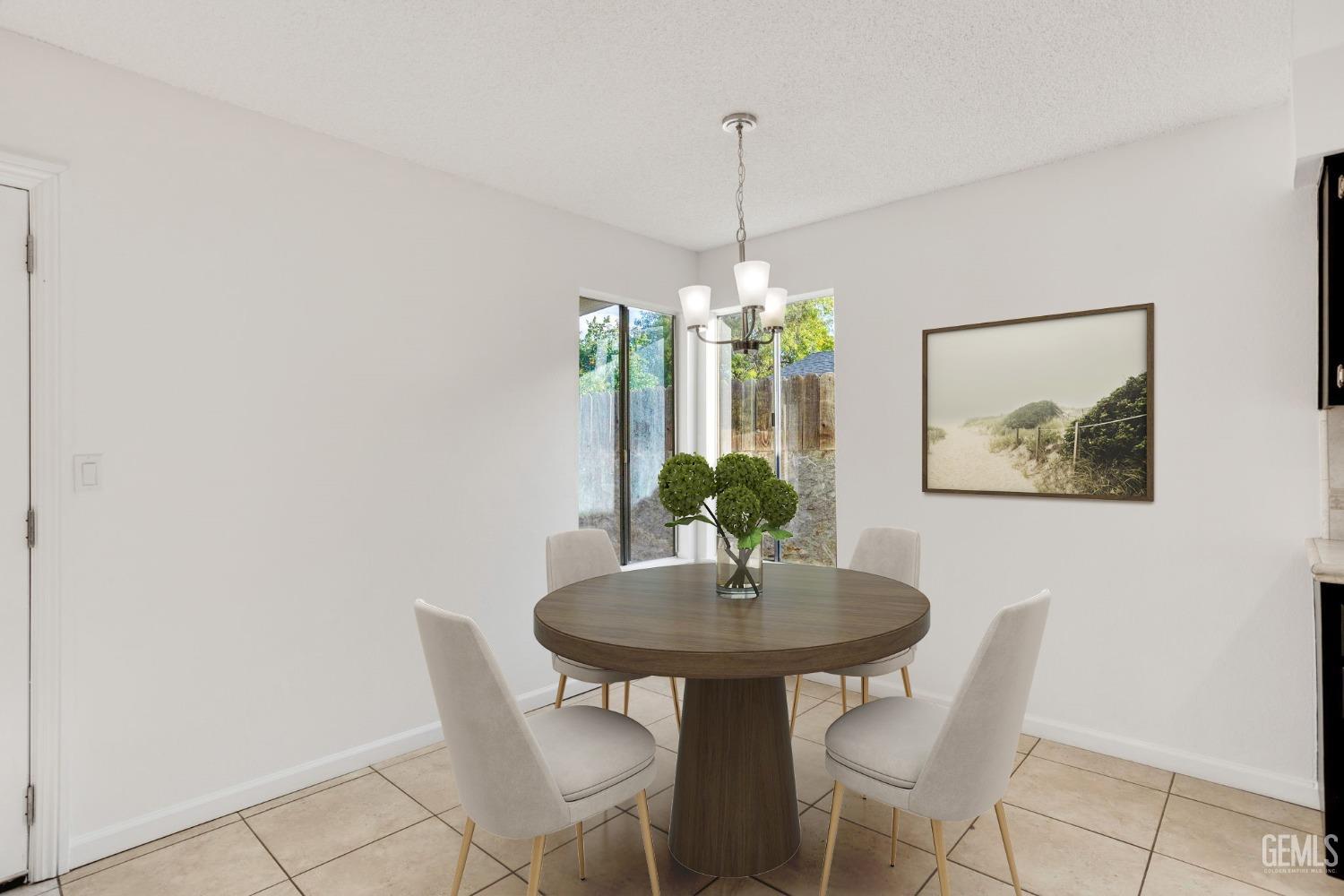 Undisclosed Address Bakersfield, CA 93304 - Photo 7 of 31 a view of a dining room with a table and chairs