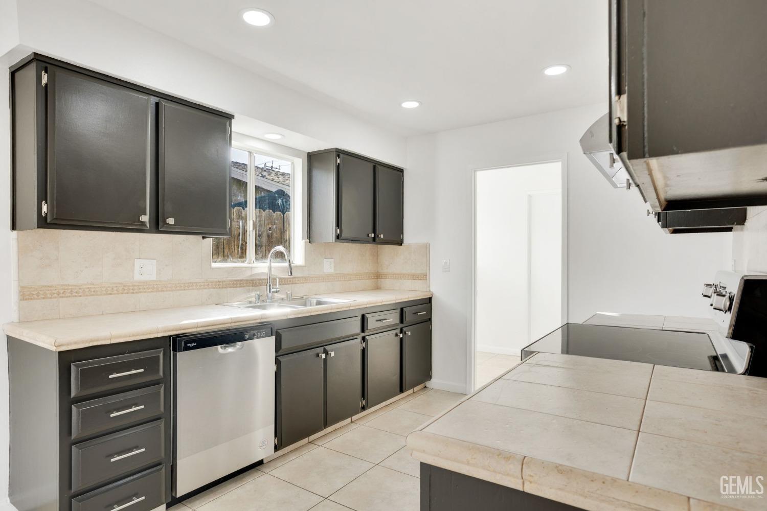 Undisclosed Address Bakersfield, CA 93304 - Photo 10 of 31 a spacious bathroom with a granite countertop sink a large mirror and a bathtub