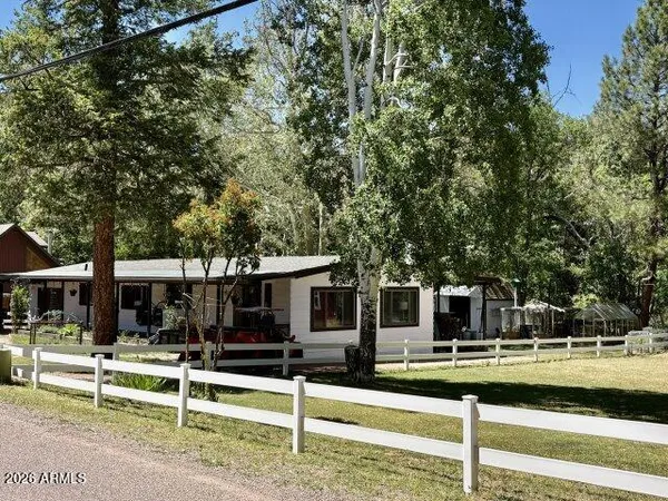 front view of house with a yard and sitting area