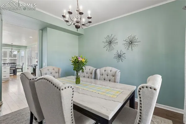 a view of a dining room with furniture and chandelier