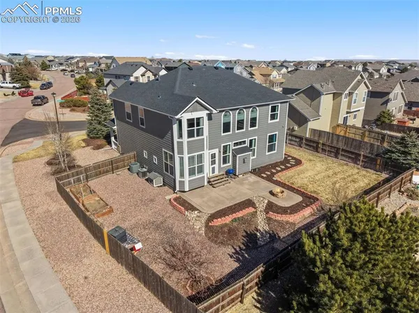 an aerial view of a house with a big yard