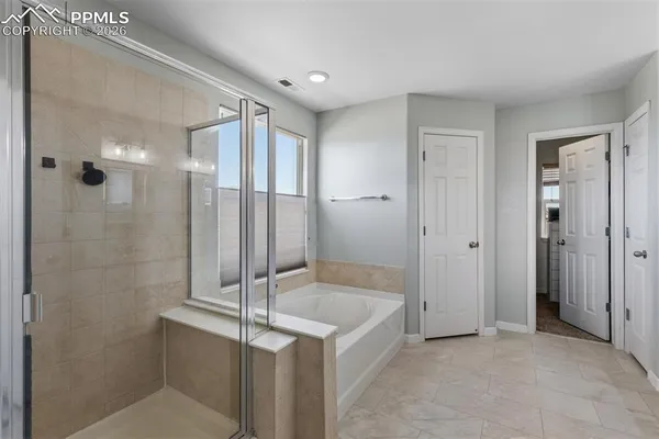 a bathroom with a shower and a sink