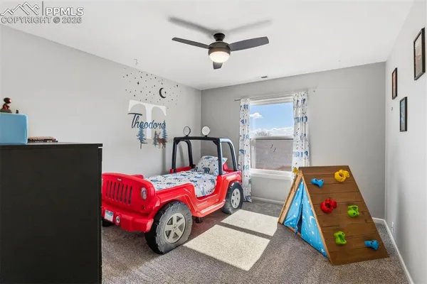 a bedroom with two beds and a chandelier
