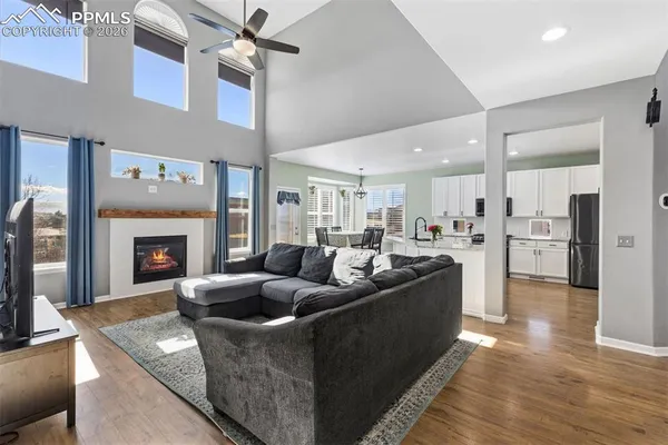 a living room with furniture wooden floor and a fireplace