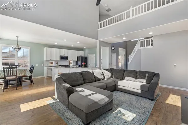 a living room with furniture and kitchen view