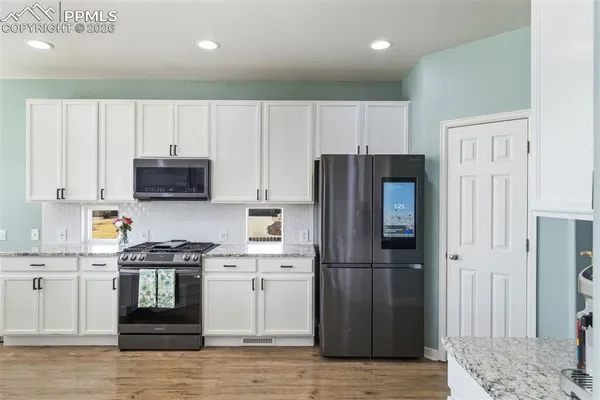 a kitchen with stainless steel appliances a refrigerator stove and sink