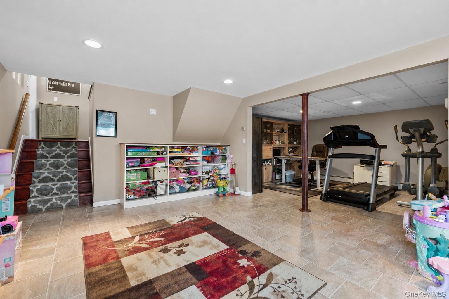 61 Winthrop Road Plainview, NY 11803 - Photo 26 of 37 a room with gym equipment and a table