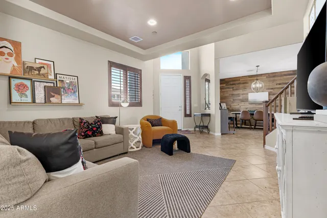 a living room with furniture and a lamp