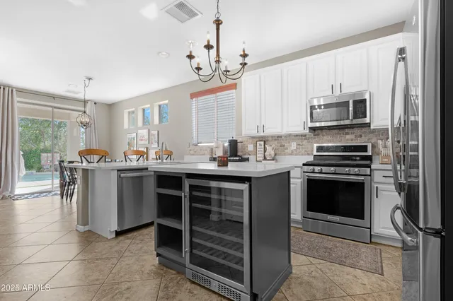 a kitchen with stainless steel appliances a refrigerator sink and cabinets