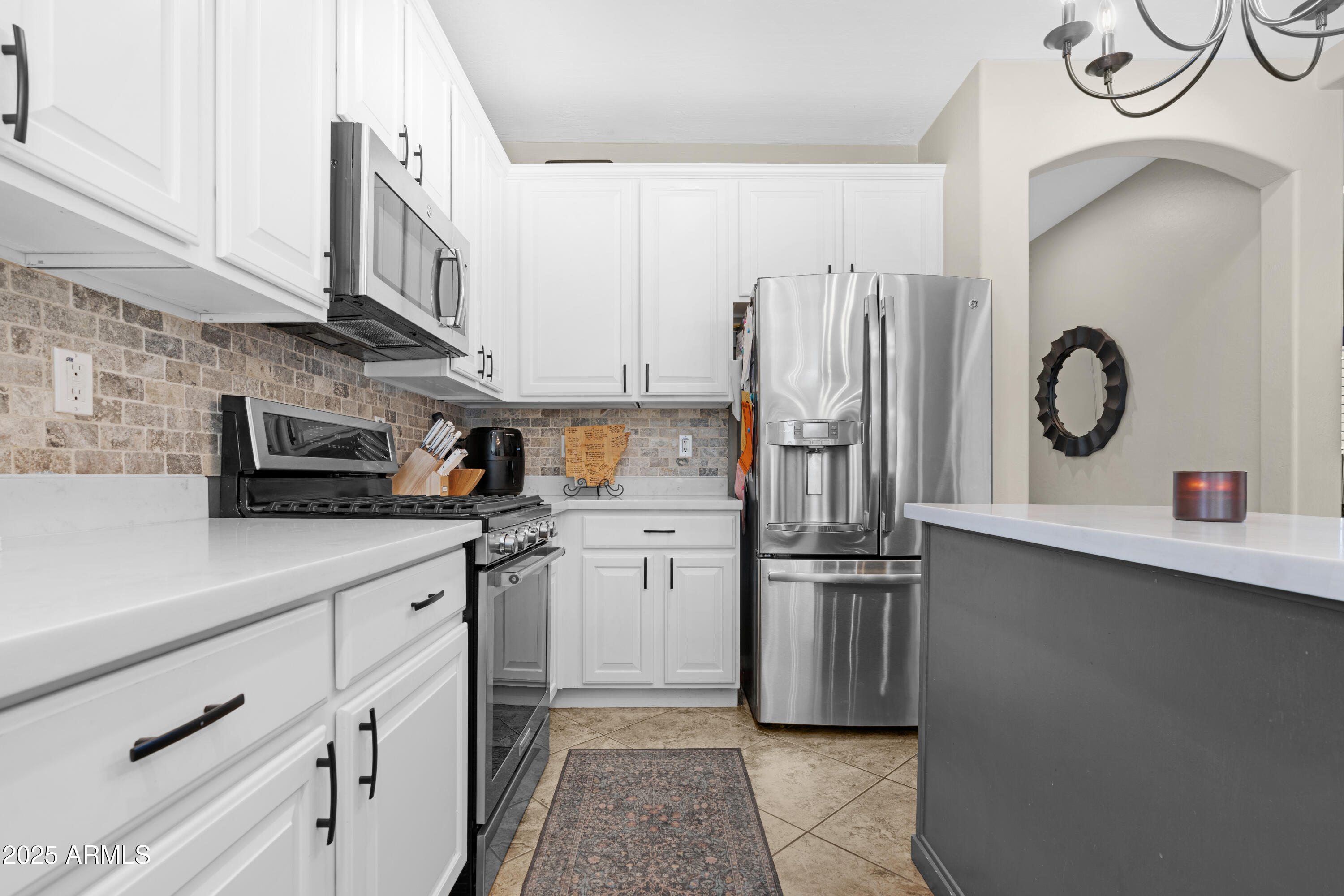 5419 West Tether Trail Phoenix, AZ 85083 - Photo 15 of 58 a kitchen with stainless steel appliances a refrigerator sink and cabinets
