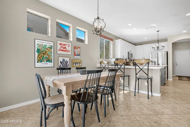 a view of a dining room with furniture and a chandelier