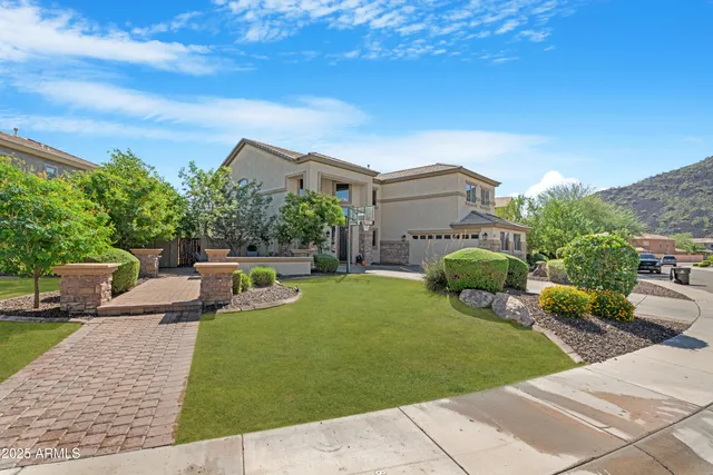 a view of a patio with couches and table and chairs with wooden fence