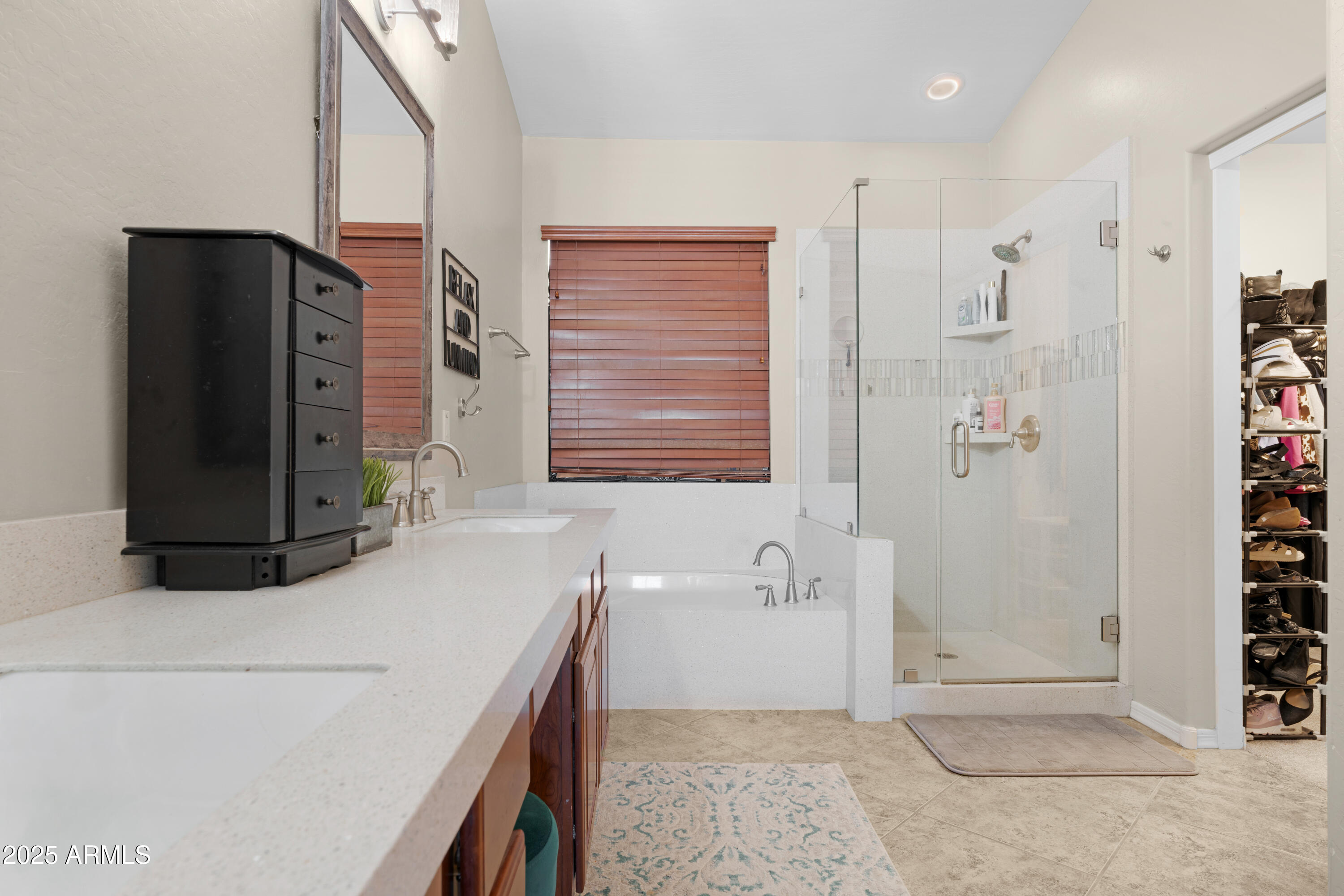 5419 West Tether Trail Phoenix, AZ 85083 - Photo 35 of 58 a bathroom with a granite countertop sink a mirror a shower and a bathtub