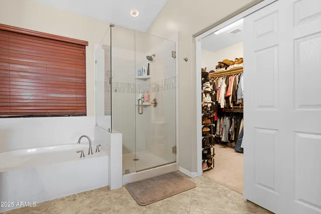 a spacious bathroom with a double vanity sink a mirror and a bathtub