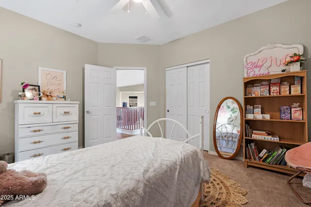 a bedroom with a bed a table and a couch