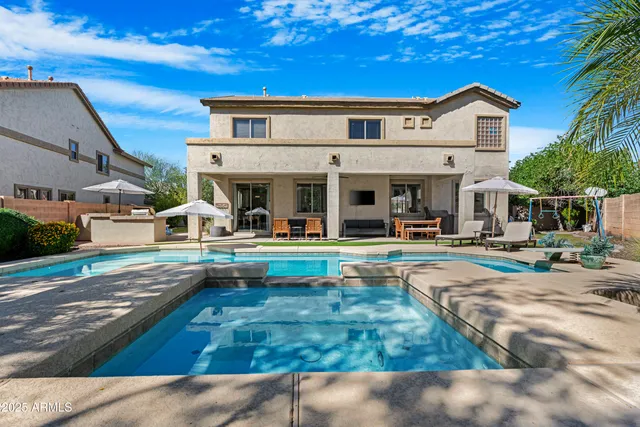 a view of a chairs and table in backyard