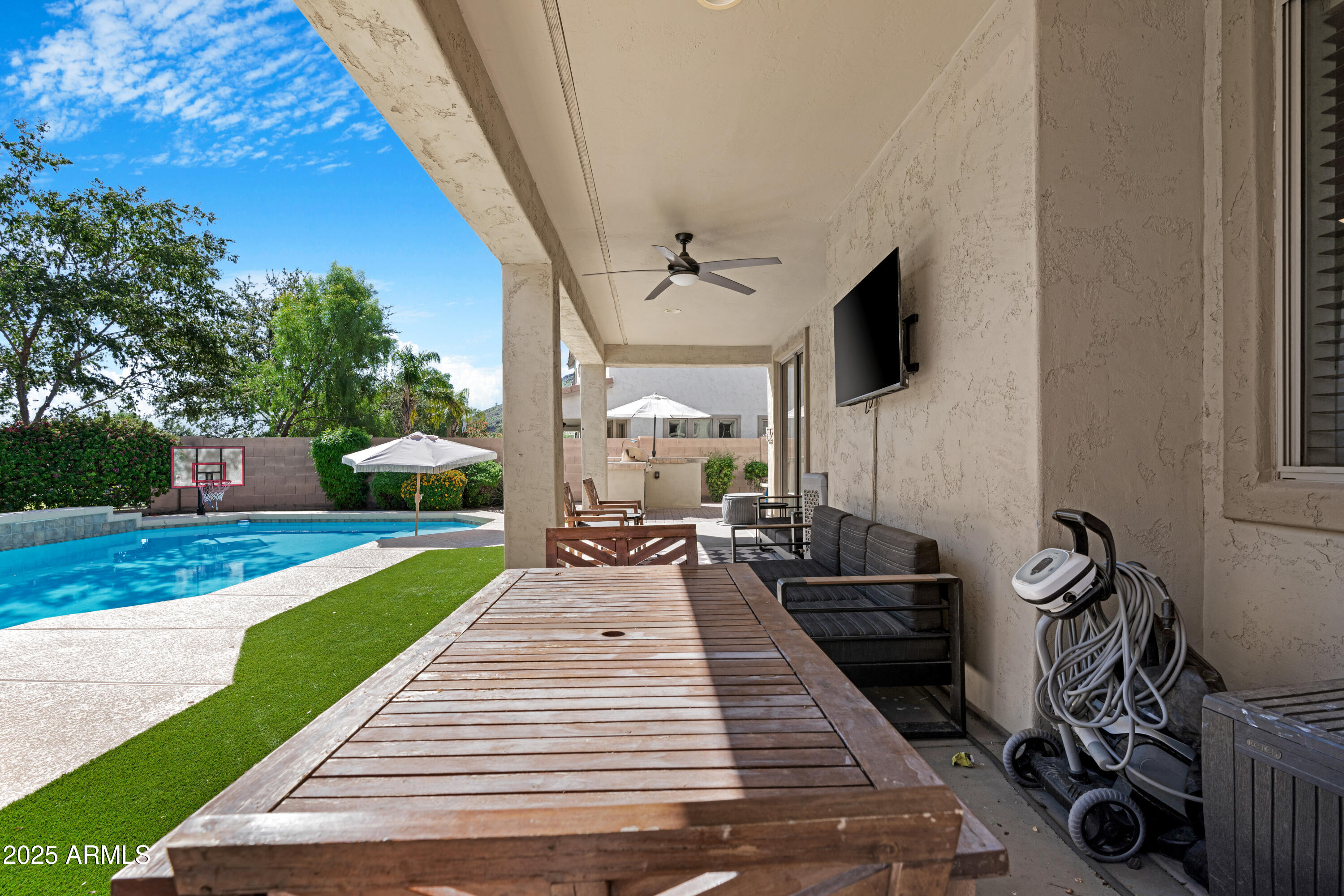 5419 West Tether Trail Phoenix, AZ 85083 - Photo 53 of 58 a patio with wooden table and chairs