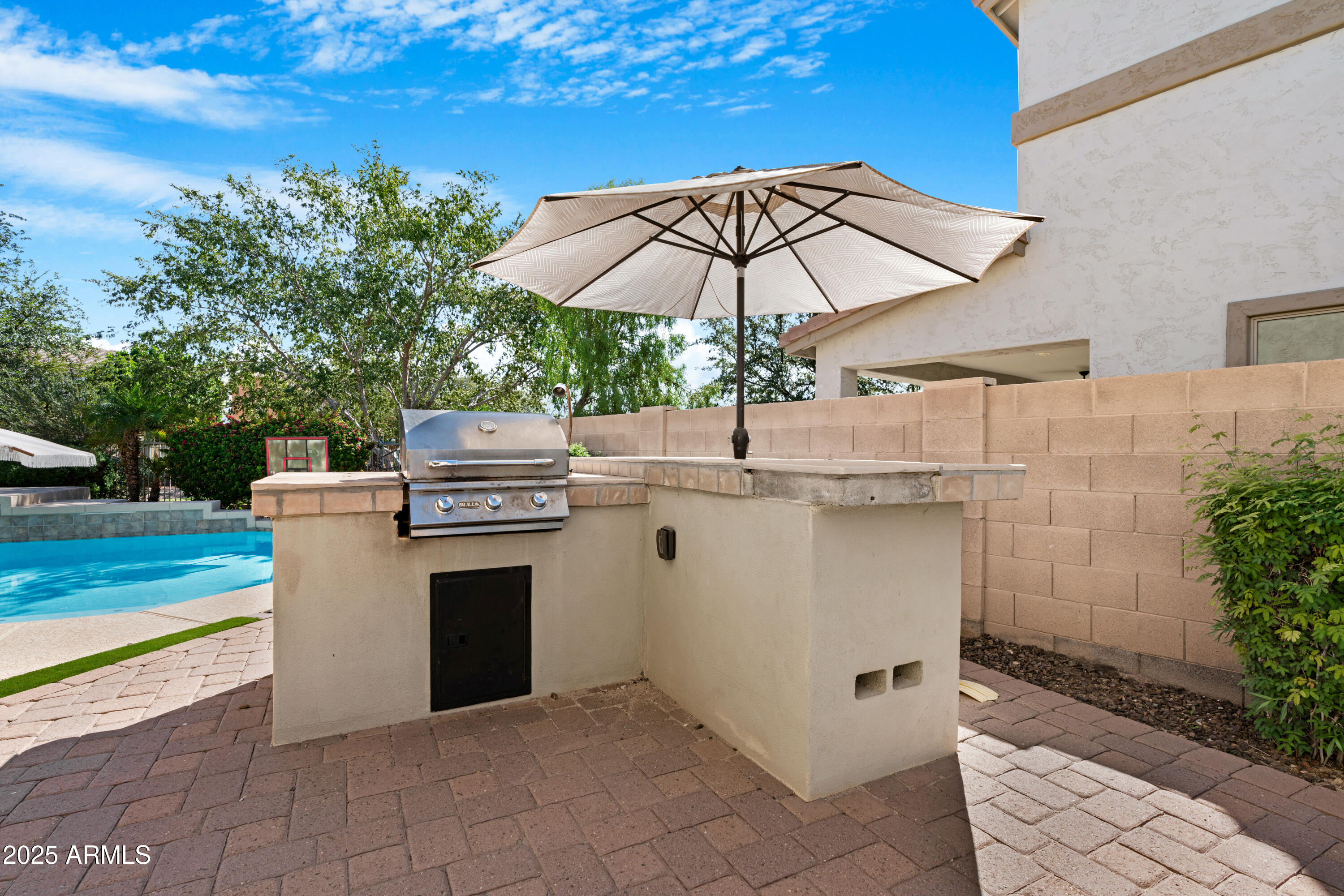 5419 West Tether Trail Phoenix, AZ 85083 - Photo 55 of 58 a view of a terrace with chairs and an umbrella