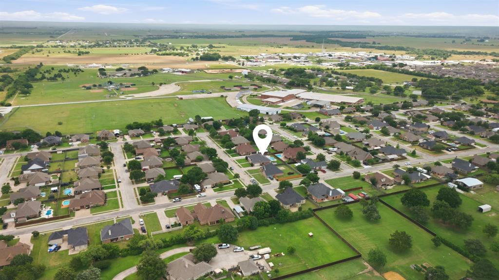 603 Cedar Drive Pilot Point, TX 76258 - Photo 35 of 39 Residential neighborhood featuring single-story homes with dark roofs and mature landscaping