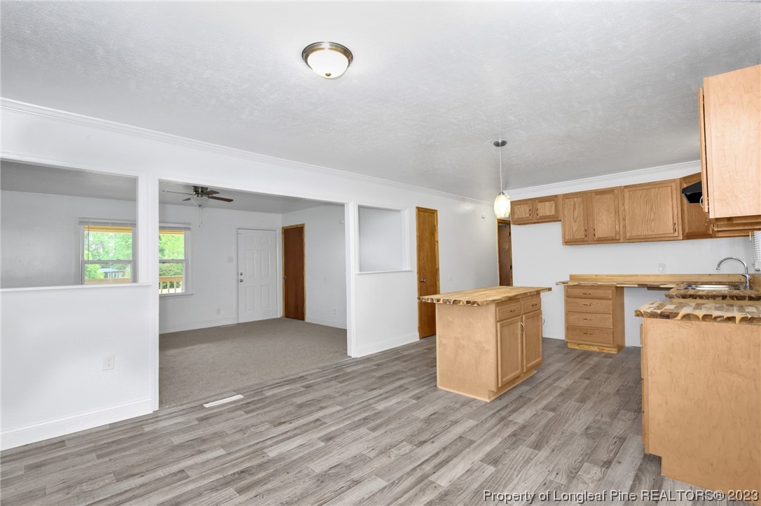 760 Horne Road Rowland, NC 28383 - Photo 11 of 30 a kitchen with a refrigerator and a stove top oven