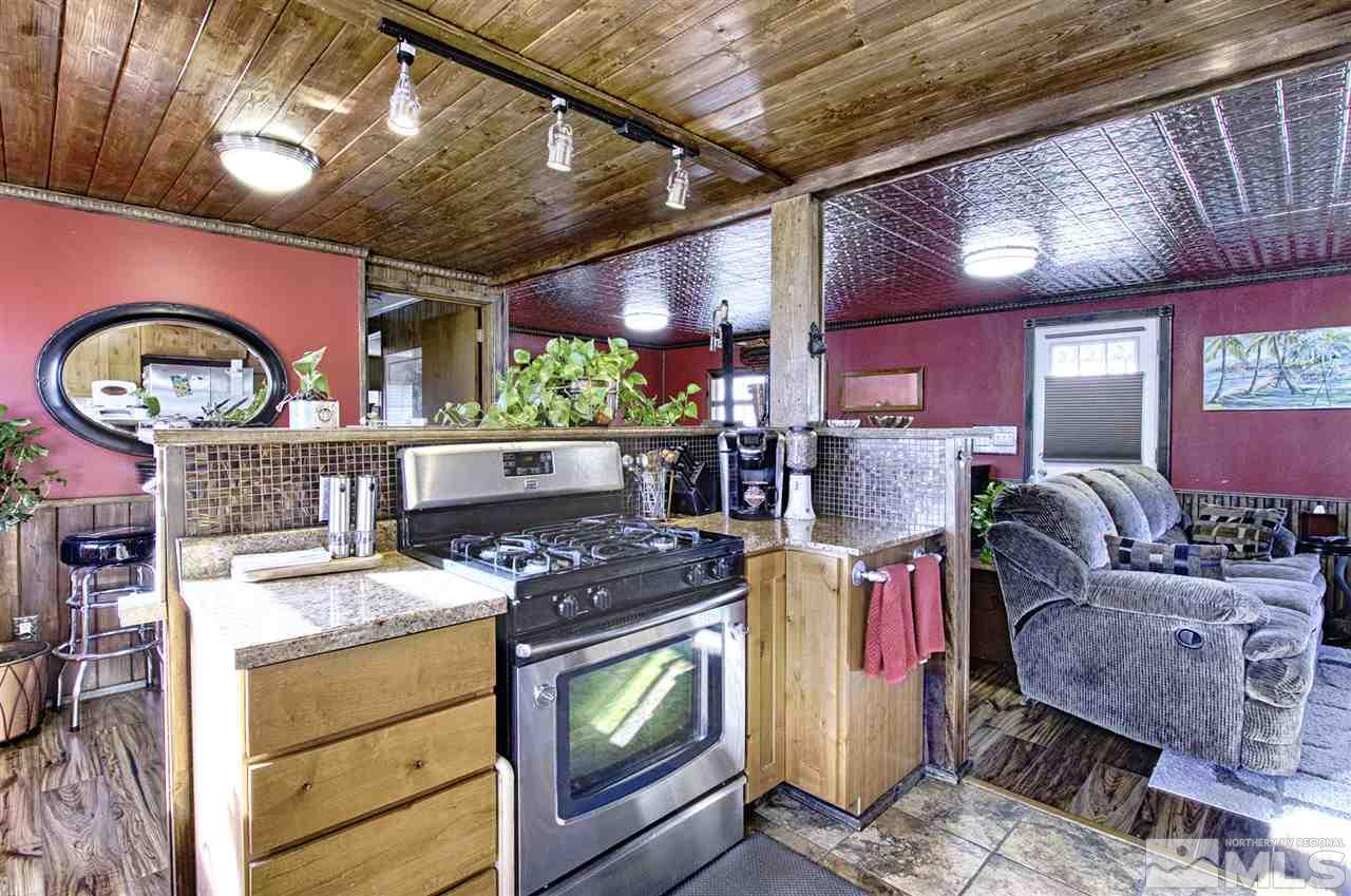 15085 Rhyolite Circle Reno, NV 89521 - Photo 4 of 23 a kitchen with stainless steel appliances granite countertop a stove and a sink