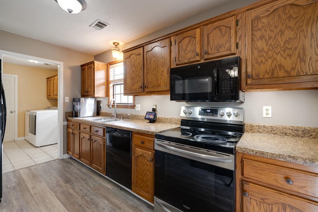 6943 Doefield Trail Bartlett, TN 38135 - Photo 12 of 32 a kitchen with stainless steel appliances wooden cabinets and a stove top oven