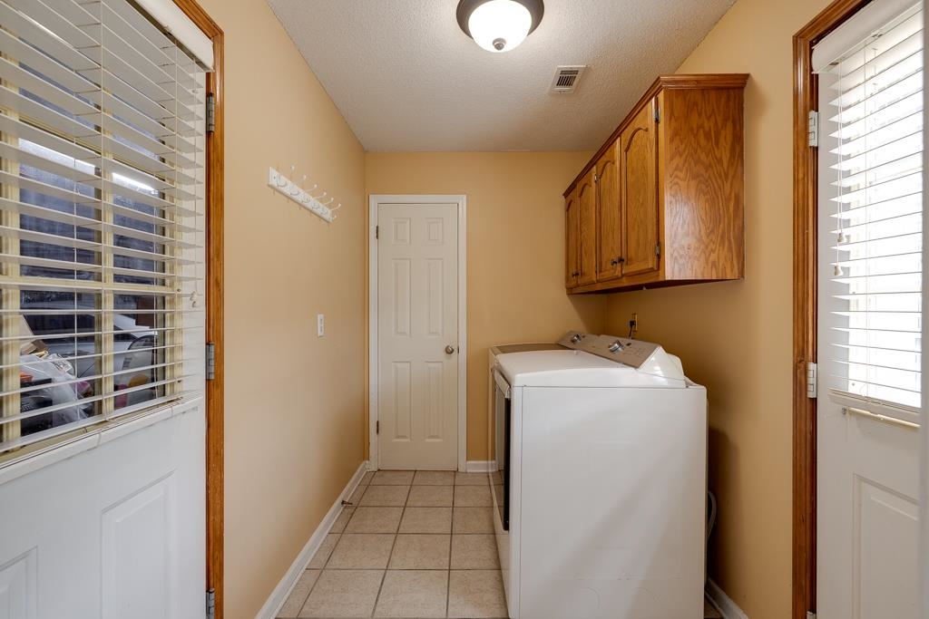 6943 Doefield Trail Bartlett, TN 38135 - Photo 14 of 32 a utility room with dryer and washer