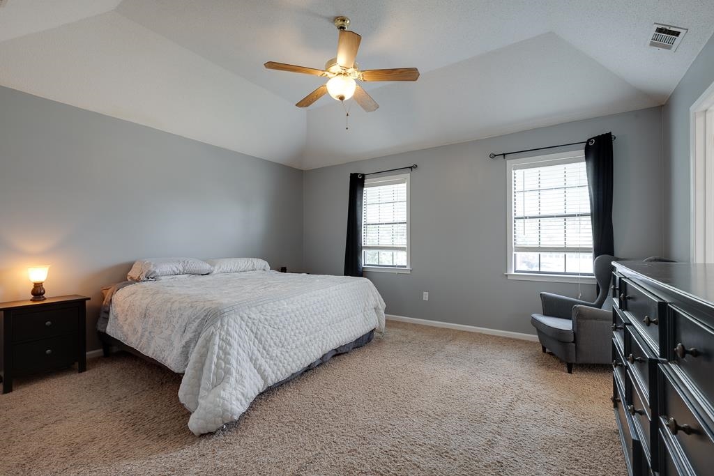 6943 Doefield Trail Bartlett, TN 38135 - Photo 18 of 32 a spacious bedroom with a bed and a chandelier