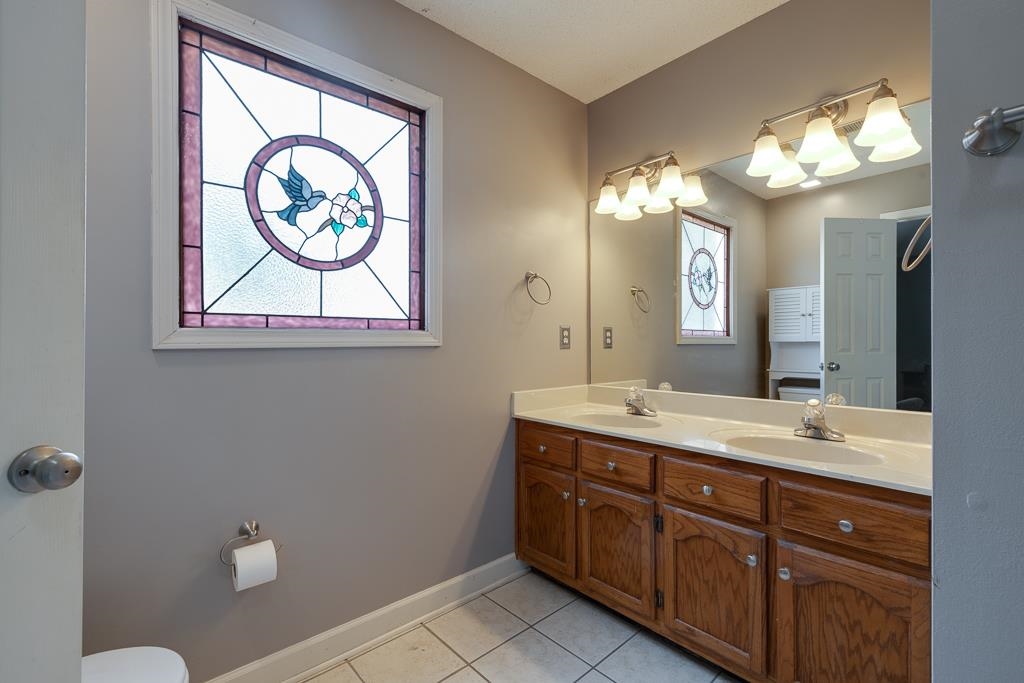 6943 Doefield Trail Bartlett, TN 38135 - Photo 20 of 32 a bathroom with a double vanity sink and a mirror