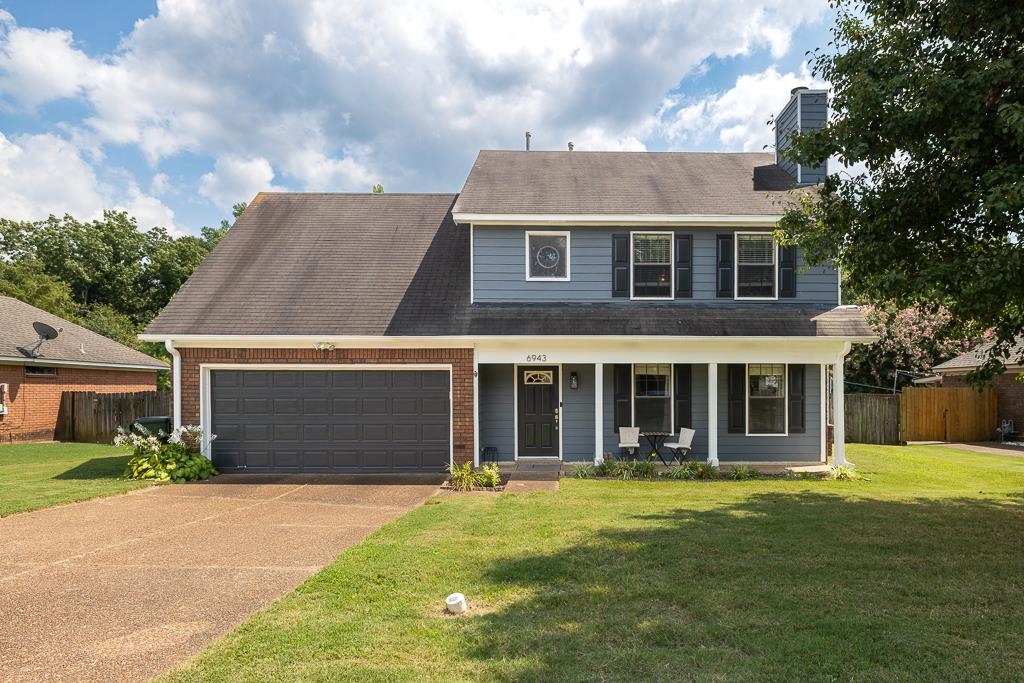 6943 Doefield Trail Bartlett, TN 38135 - Photo 2 of 32 a front view of a house with a yard and garage