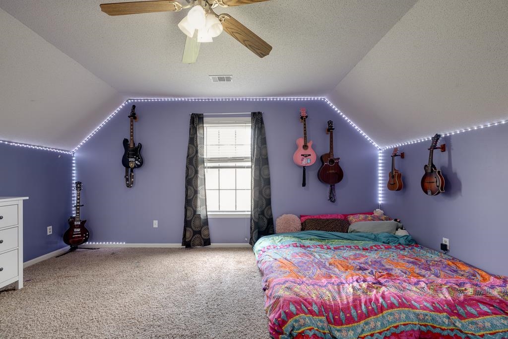 6943 Doefield Trail Bartlett, TN 38135 - Photo 24 of 32 a bedroom with a bed and a chandelier