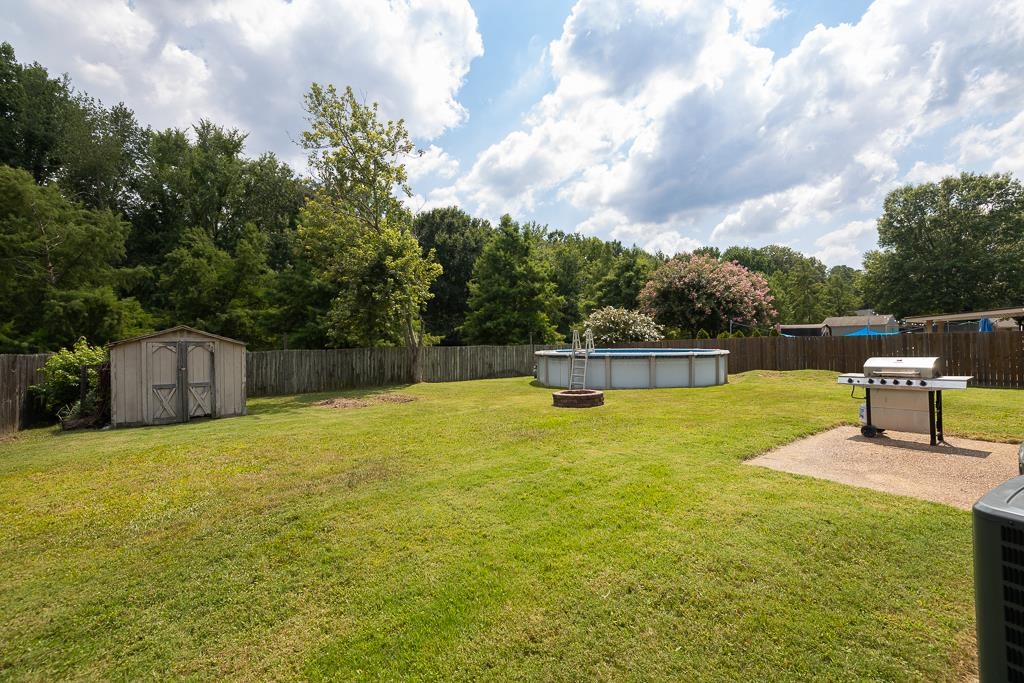 6943 Doefield Trail Bartlett, TN 38135 - Photo 29 of 32 a swimming pool with a lots of trees in the background