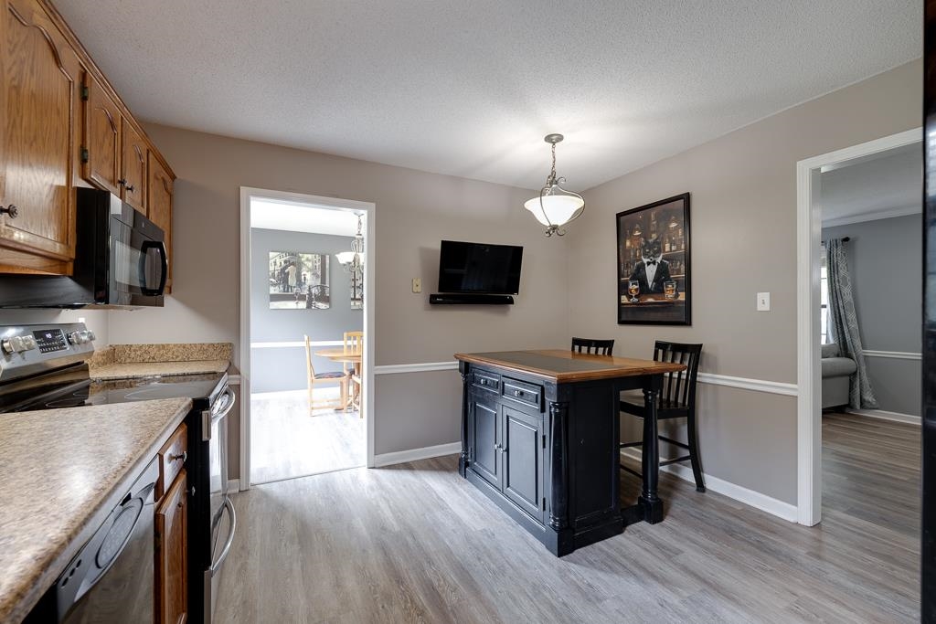 6943 Doefield Trail Bartlett, TN 38135 - Photo 8 of 32 a kitchen with a stove cabinets and wooden floor