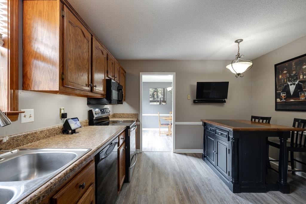 6943 Doefield Trail Bartlett, TN 38135 - Photo 9 of 32 a kitchen with a sink a counter top space stainless steel appliances and a window