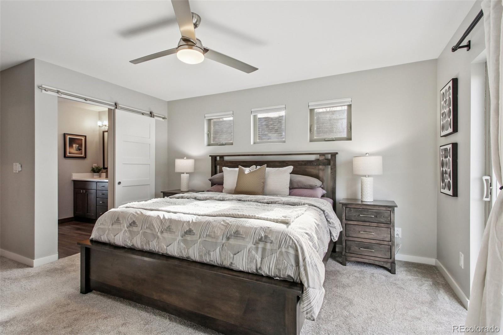 4132 Stuart Street Denver, CO 80212 - Photo 17 of 35 a bedroom with a bed and a lamp