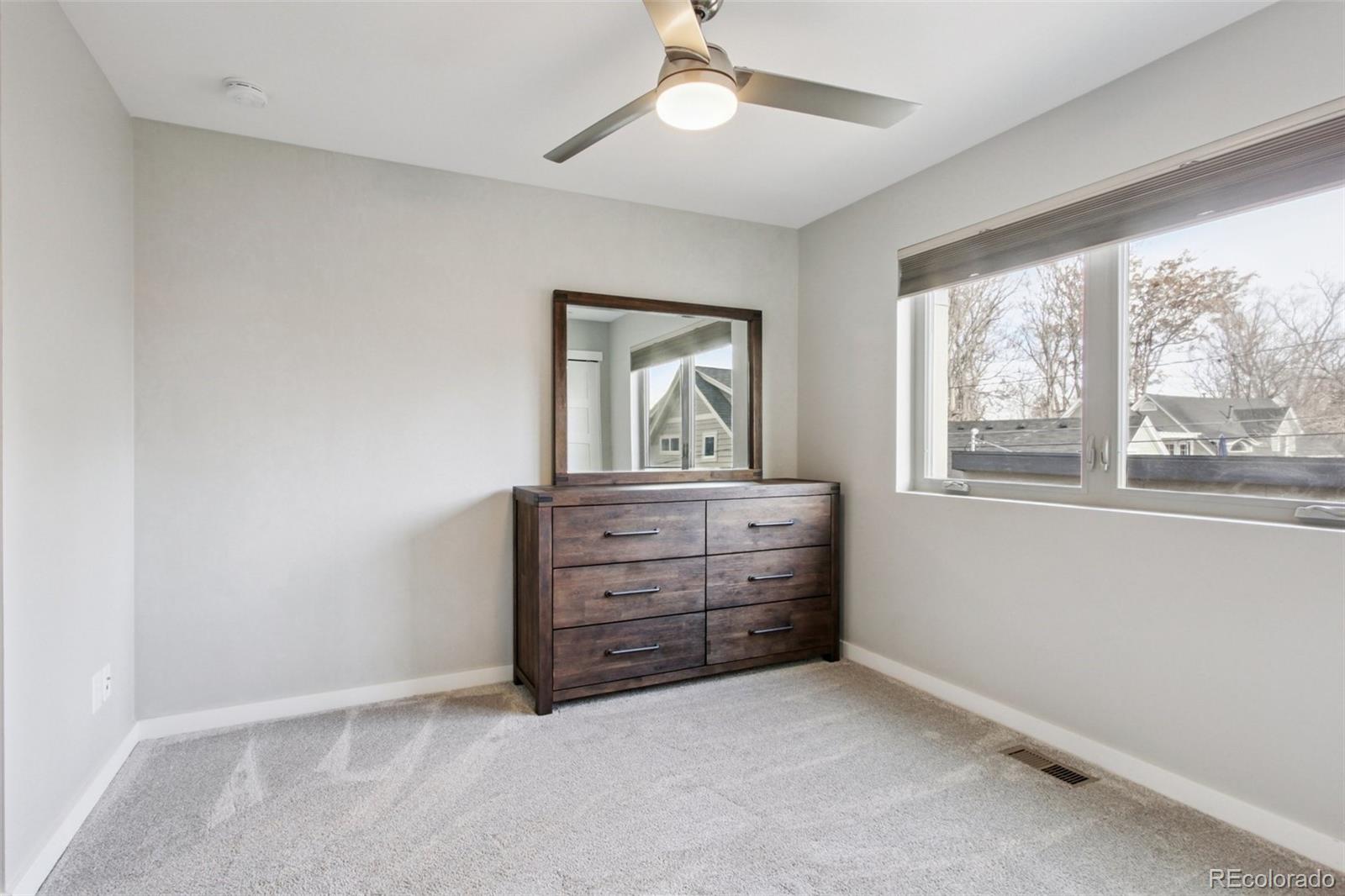 4132 Stuart Street Denver, CO 80212 - Photo 24 of 35 an empty room with windows and cabinet