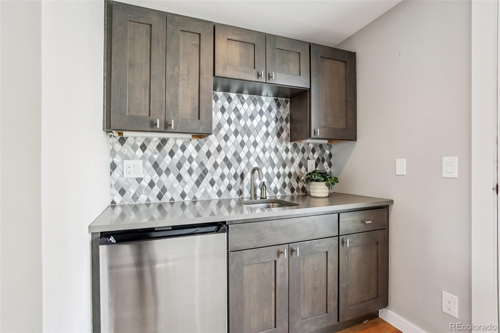4132 Stuart Street Denver, CO 80212 - Photo 26 of 35 a kitchen with a sink and cabinets