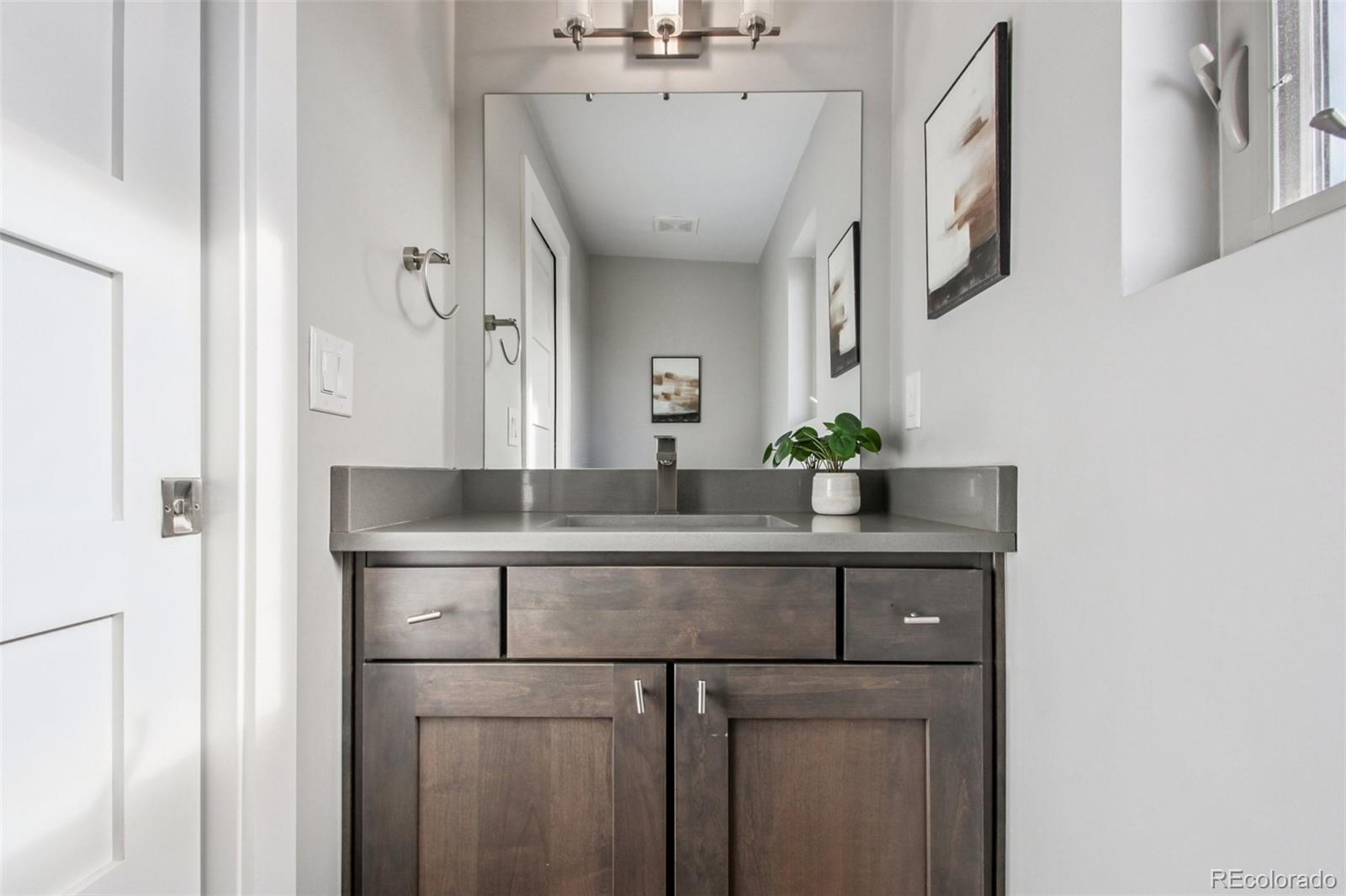 4132 Stuart Street Denver, CO 80212 - Photo 29 of 35 a bathroom with a sink and a mirror