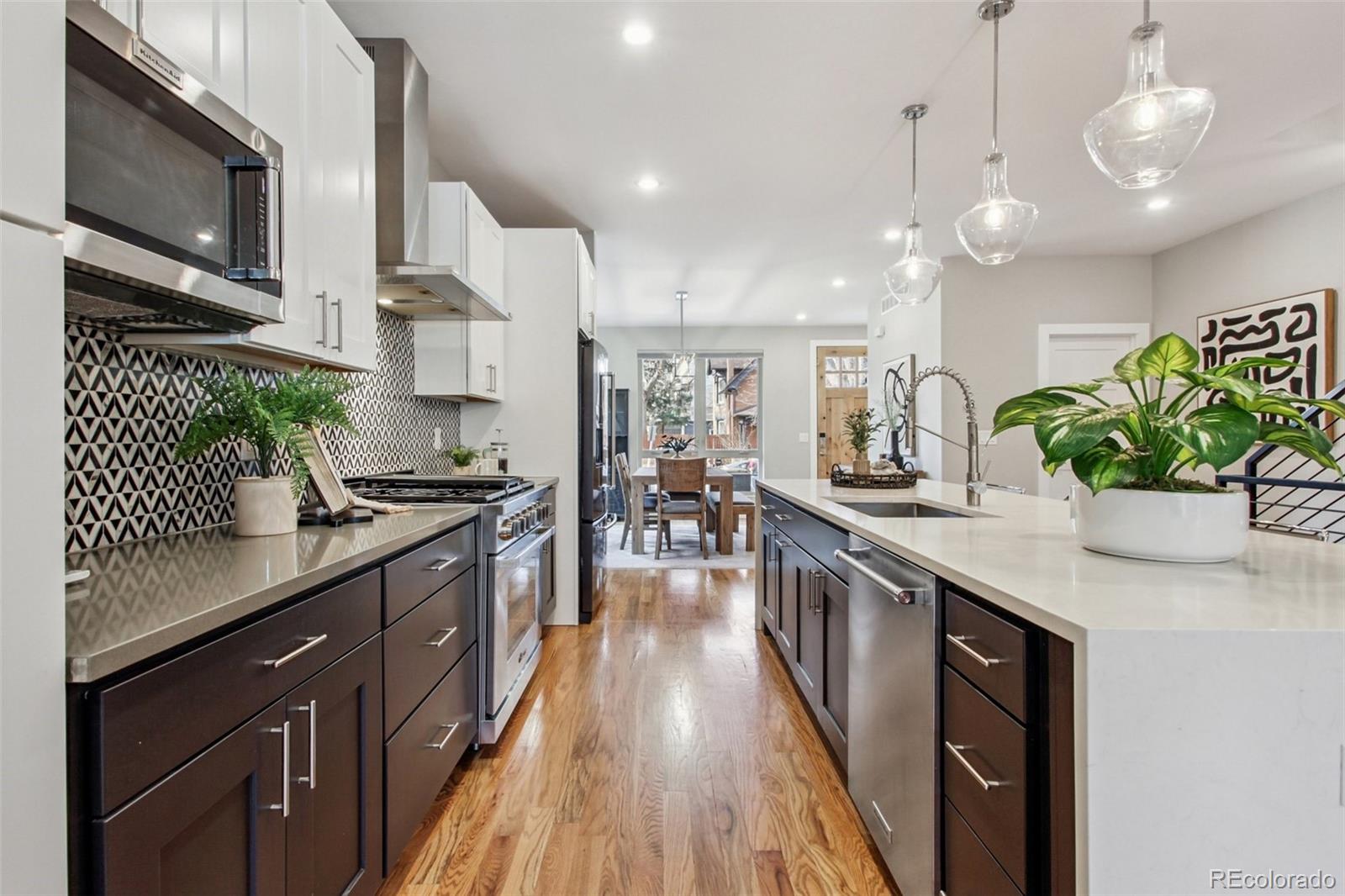 4132 Stuart Street Denver, CO 80212 - Photo 8 of 35 a kitchen with stainless steel appliances granite countertop sink stove top oven and cabinets
