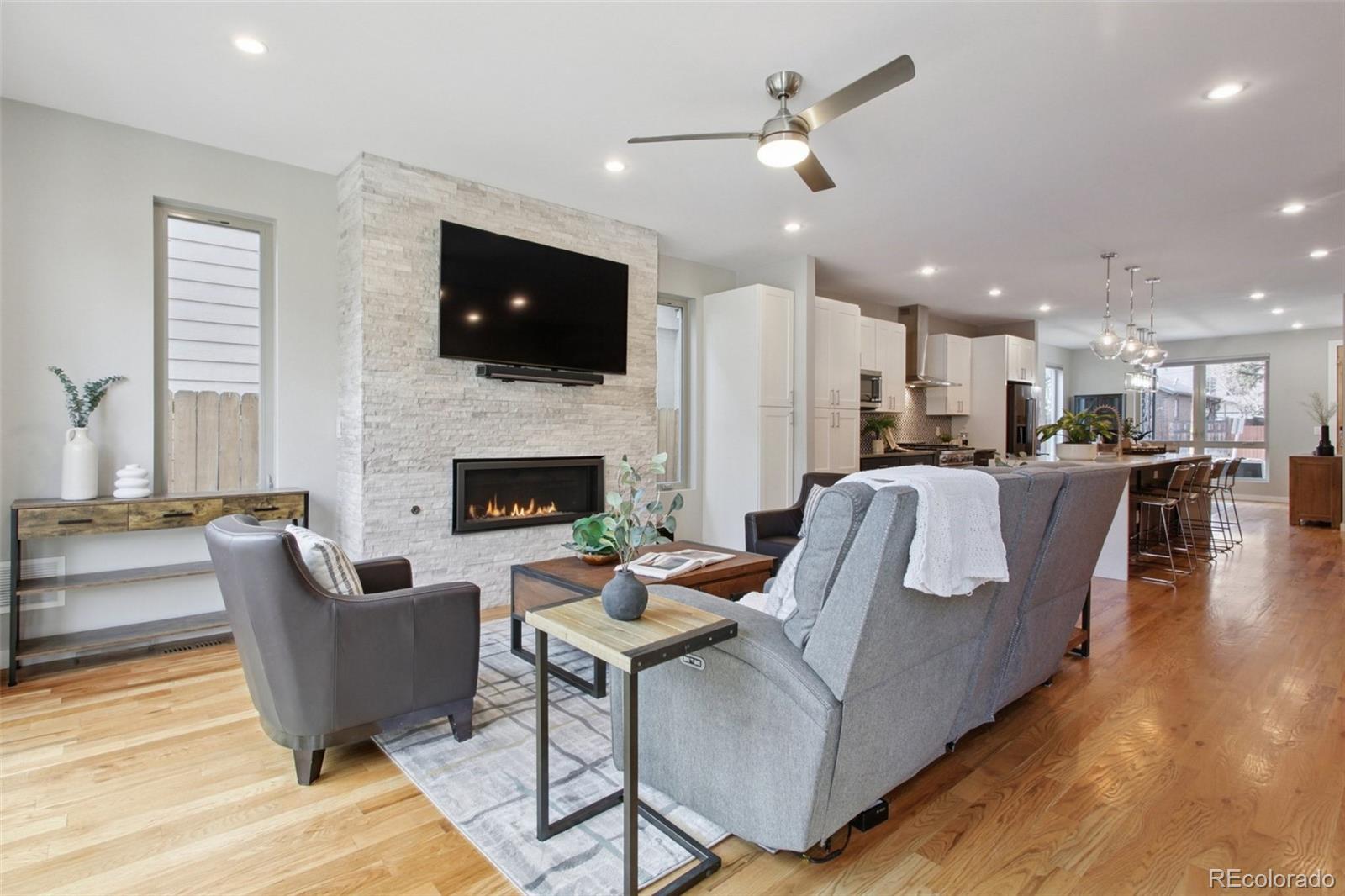 4132 Stuart Street Denver, CO 80212 - Photo 10 of 35 a living room with furniture kitchen and a fireplace