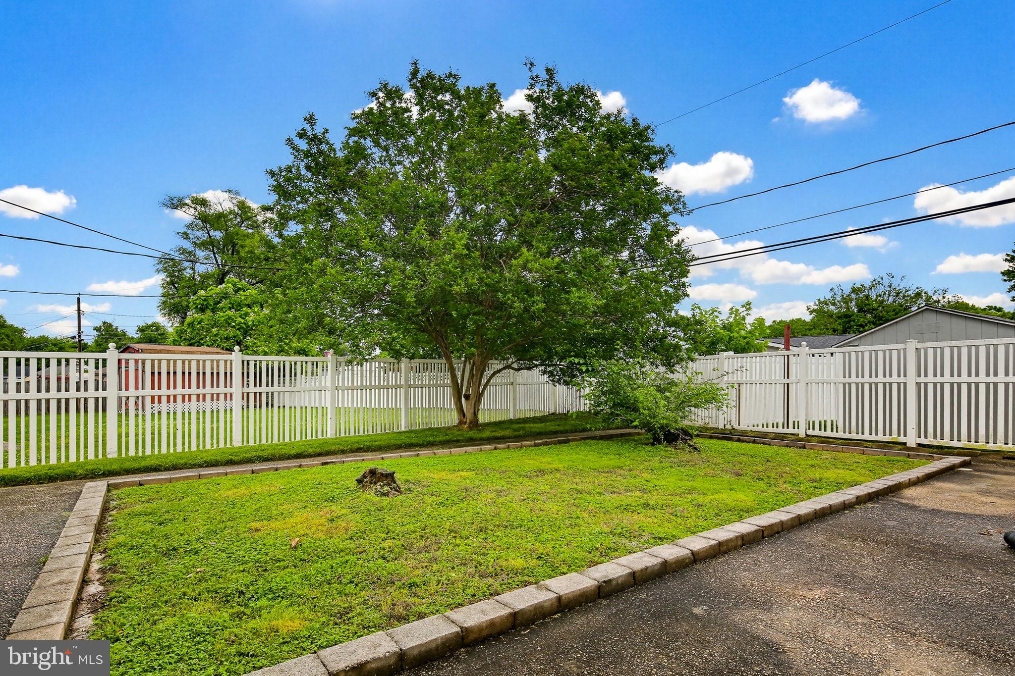 1124 Wynbrook Road Glen Burnie, MD 21060 - Photo 26 of 32 Lush green yard with white fencing.
