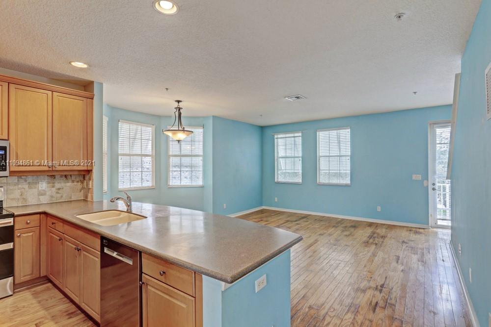 1541 Frederick Small Road, Unit 1541 Jupiter, FL 33458 - Photo 14 of 56 a kitchen with a sink cabinets and wooden floor