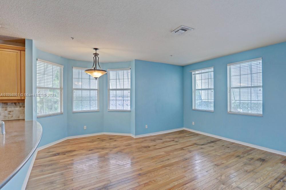 1541 Frederick Small Road, Unit 1541 Jupiter, FL 33458 - Photo 15 of 56 a view of empty room with wooden floor and fan