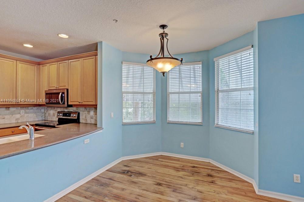 1541 Frederick Small Road, Unit 1541 Jupiter, FL 33458 - Photo 16 of 56 a kitchen with stainless steel appliances granite countertop a sink a stove and a window