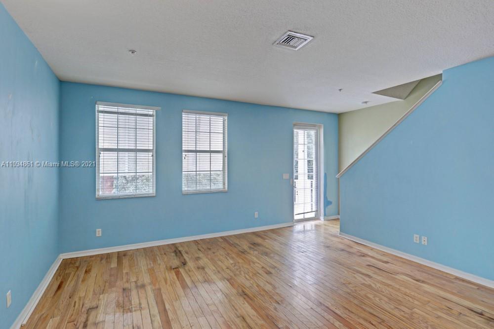 1541 Frederick Small Road, Unit 1541 Jupiter, FL 33458 - Photo 18 of 56 a view of an empty room with wooden floor and a window
