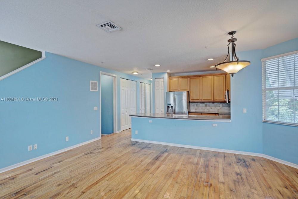 1541 Frederick Small Road, Unit 1541 Jupiter, FL 33458 - Photo 20 of 56 a view of kitchen and hallway with wooden floor
