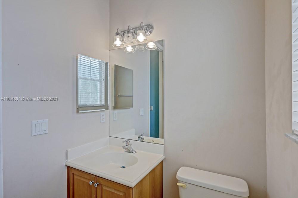 1541 Frederick Small Road, Unit 1541 Jupiter, FL 33458 - Photo 27 of 56 a bathroom with a sink a toilet and a mirror