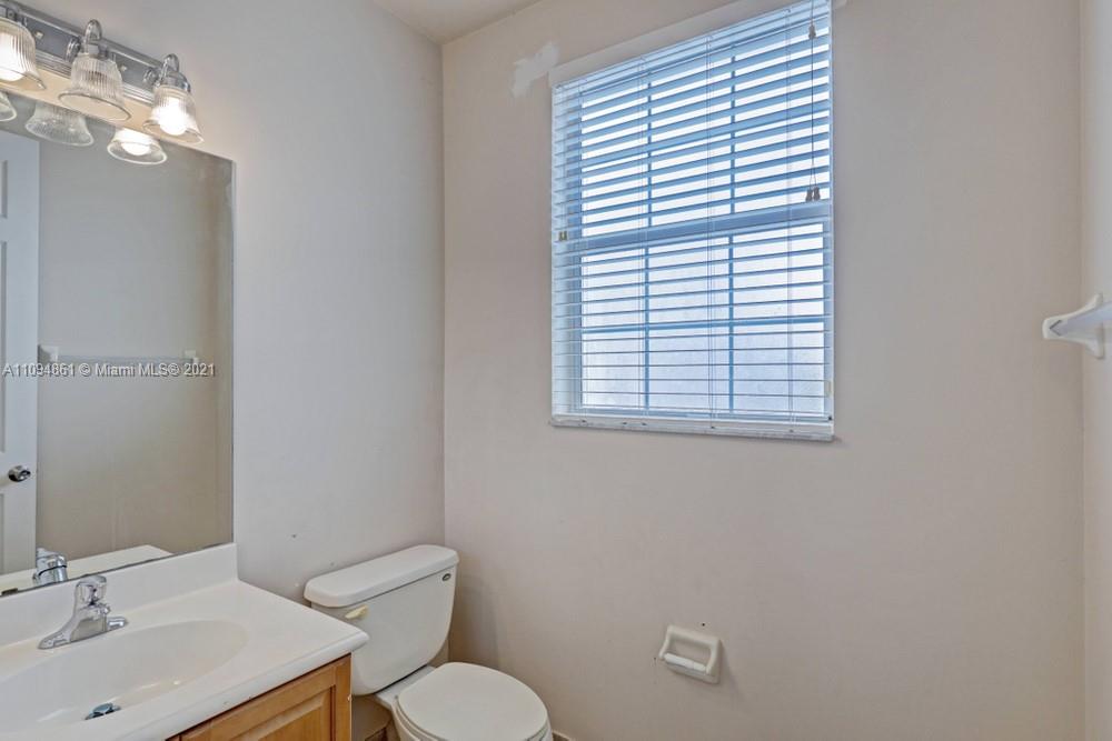 1541 Frederick Small Road, Unit 1541 Jupiter, FL 33458 - Photo 28 of 56 a bathroom with a toilet a sink and mirror