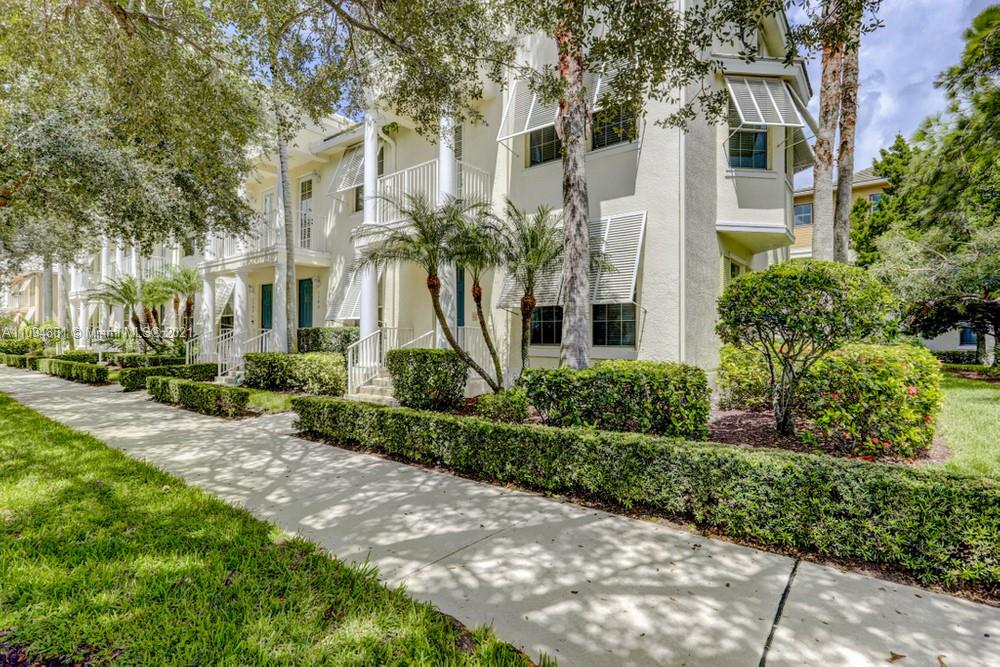 1541 Frederick Small Road, Unit 1541 Jupiter, FL 33458 - Photo 3 of 56 a front view of a multi story residential apartment building with yard and green space