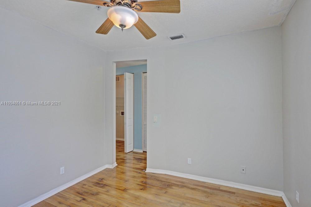 1541 Frederick Small Road, Unit 1541 Jupiter, FL 33458 - Photo 31 of 56 a view of a chandelier fan and hardwood floor